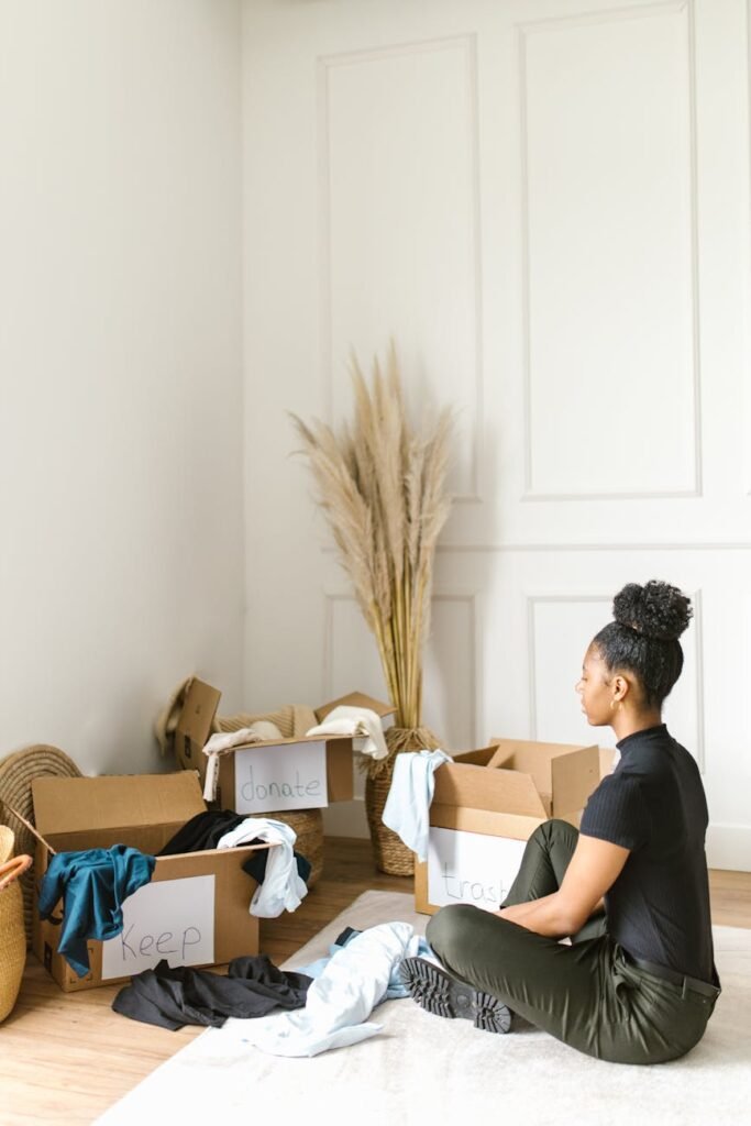 woman sitting on a rug sorting clothes